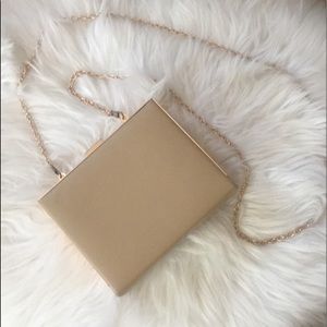 Tan hard case shoulder bag with gold accents
